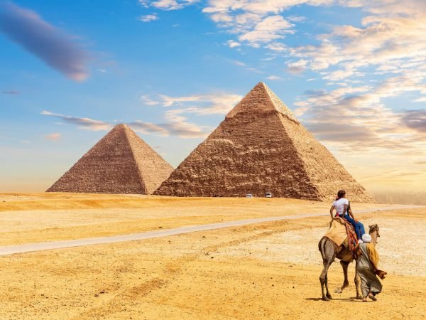 tourists-ride-a-camel-in-front-of-the-pyramids-of-Giza